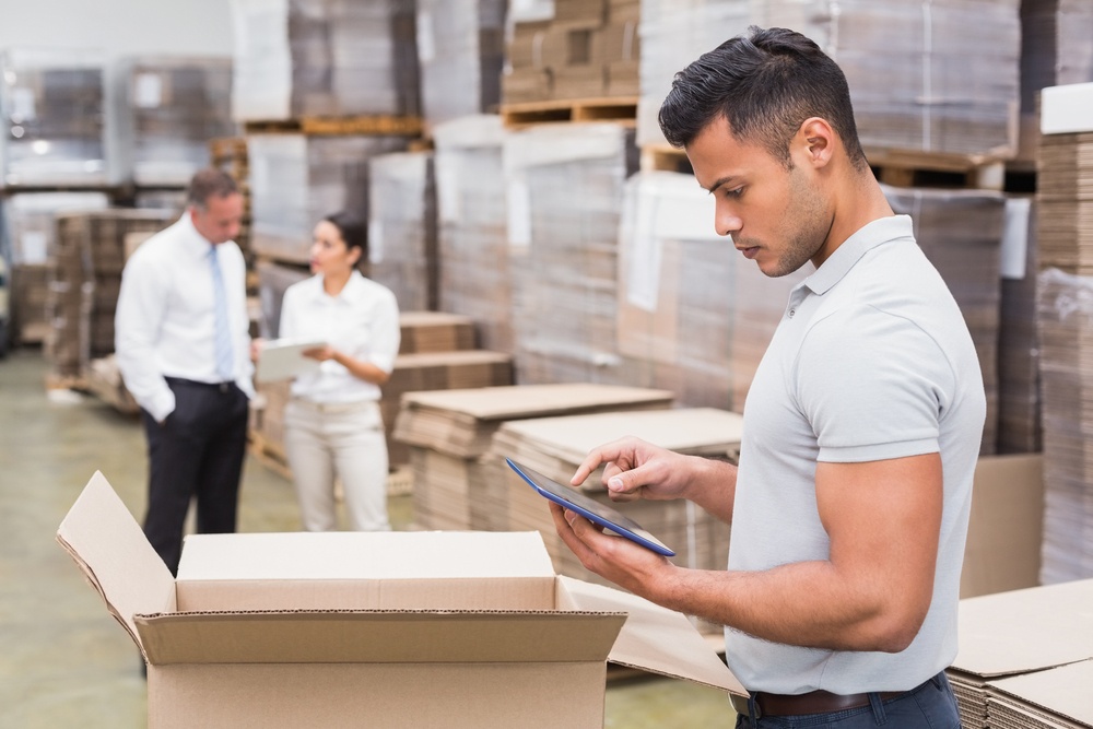 Portrait of male manager using digital tablet in warehouse.jpeg